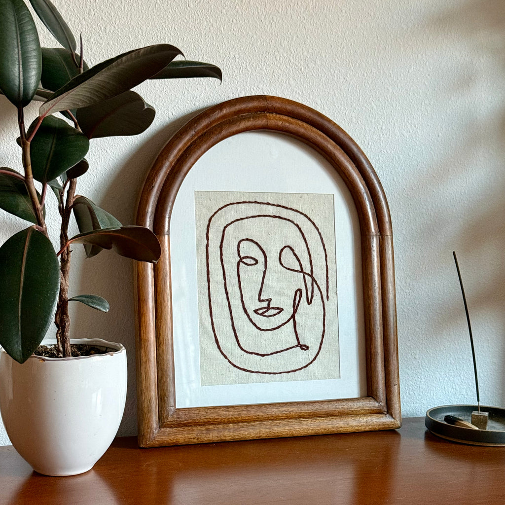 embroidered face art piece