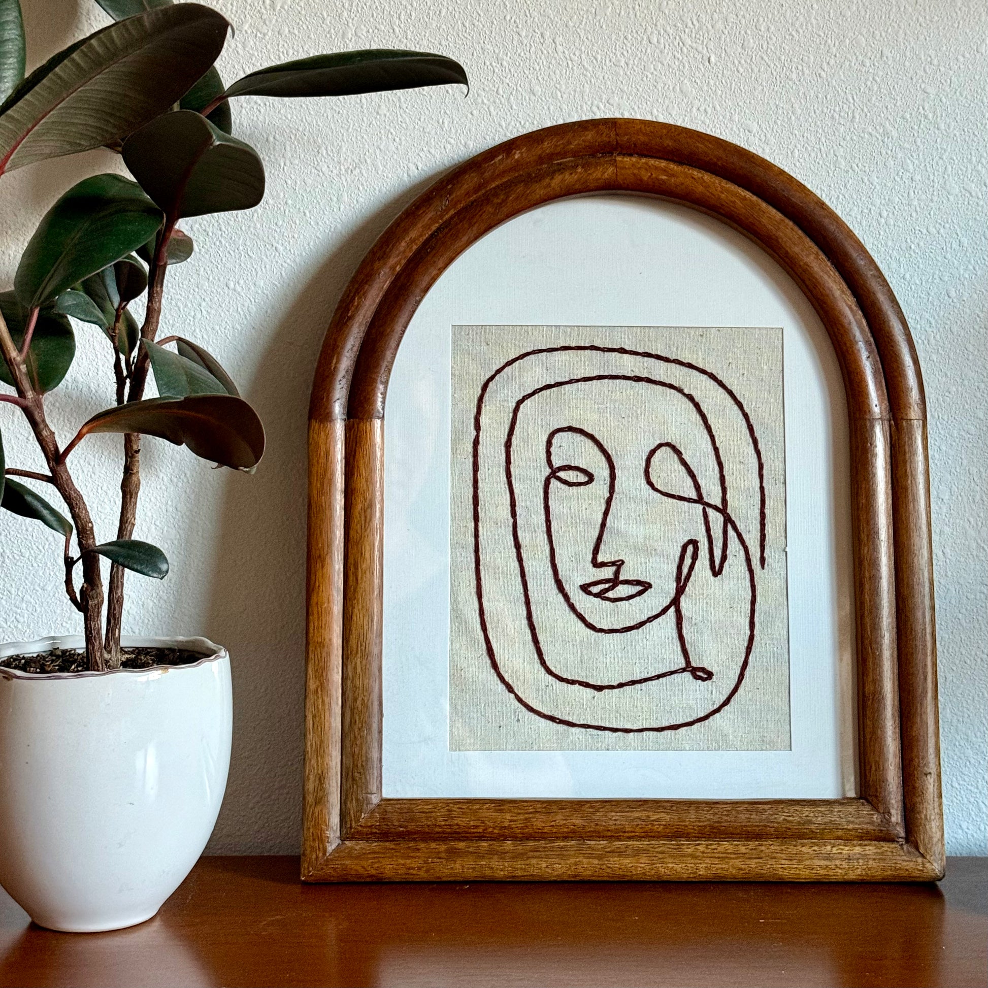 embroidered face art piece